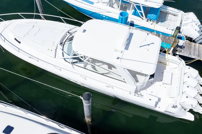 Slide: The Image of 2018 Intrepid 475 Sport Yacht docked, aerial view, sleek white design. - 31