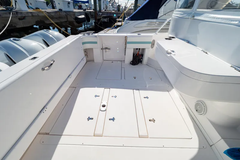 Slide: The Image of 2018 Intrepid 475 Sport Yacht deck with storage compartments and seating. - 46
