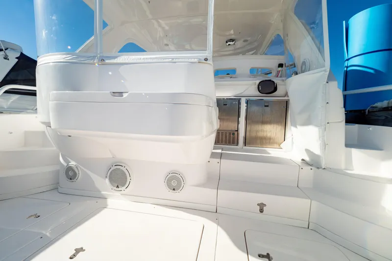 Slide: The Image of 2018 Intrepid 475 Sport Yacht cockpit with seating and storage, showcasing sleek design. - 48
