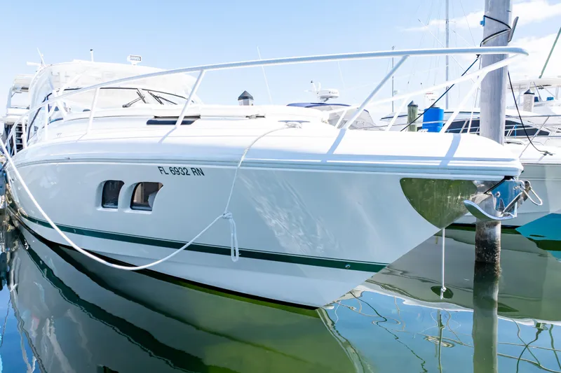 Slide: The Image of 2018 Intrepid 475 Sport Yacht docked in marina, reflecting on calm water. - 55