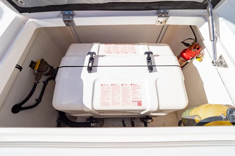 Slide: The Image of Storage compartment of a 2018 Intrepid 475 Sport Yacht with equipment and fire extinguisher. - 68