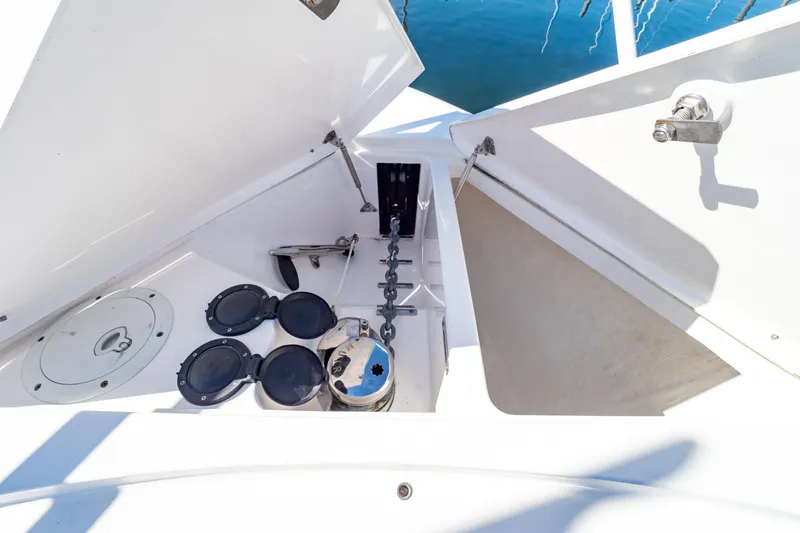 Slide: The Image of Anchor compartment of 2018 Intrepid 475 Sport Yacht with open hatches and chain. - 78