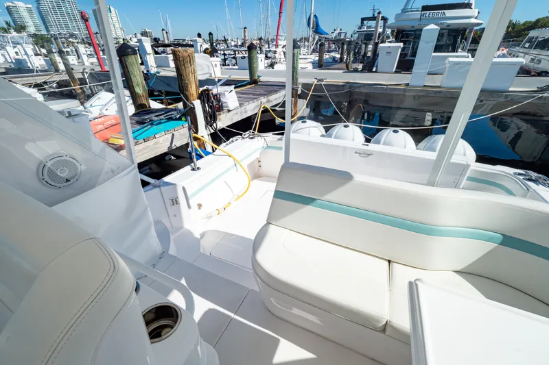 Slide: The Image of 2018 Intrepid 475 Sport Yacht docked at marina, featuring spacious seating and sleek design. - 84