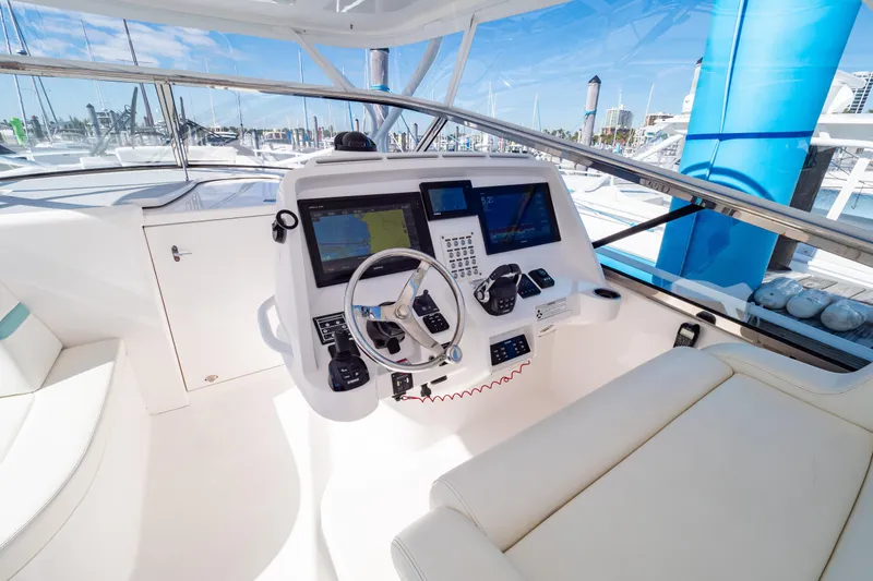 Slide: The Image of 2018 Intrepid 475 Sport Yacht helm with modern navigation equipment and luxurious seating. - 86