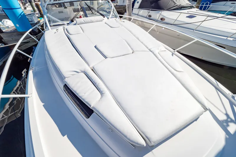 Slide: The Image of 2018 Intrepid 475 Sport Yacht with sleek white deck and luxurious seating. - 9