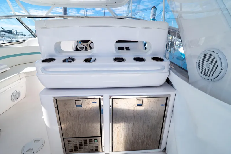 Slide: The Image of 2018 Intrepid 475 Sport Yacht interior with storage and cup holders. - 91