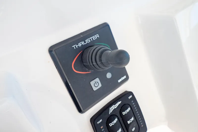 Slide: The Image of Joystick control panel on 2018 Intrepid 475 Sport Yacht, featuring thruster and trim tab controls. - 97