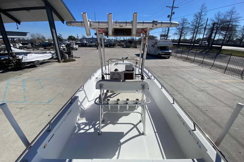 Slide: The Image of 2005 Sea Pro SV2400CC Bay Boat, docked, showcasing spacious deck and T-top. - 12