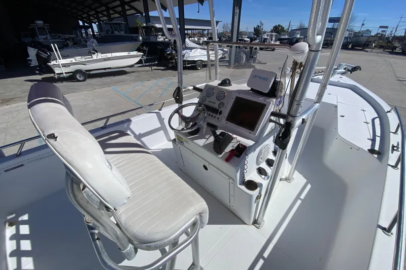 Slide: The Image of 2005 Sea Pro SV2400CC Bay Boat cockpit with steering wheel and navigation equipment. - 13