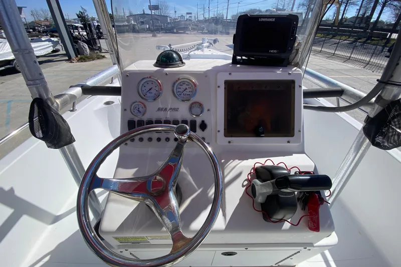 Slide: The Image of 2005 Sea Pro SV2400CC Bay Boat dashboard with steering wheel and navigation equipment. - 14