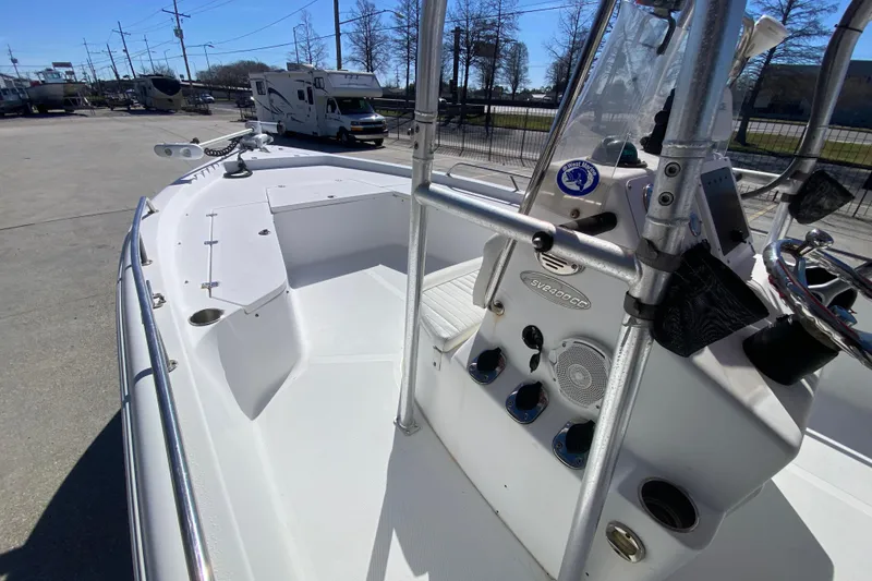 Slide: The Image of 2005 Sea Pro SV2400CC Bay Boat with center console and steering wheel, parked outdoors. - 16