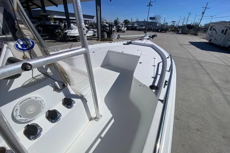 Slide: The Image of 2005 Sea Pro SV2400CC Bay Boat, white deck, marina background, sunny day. - 17