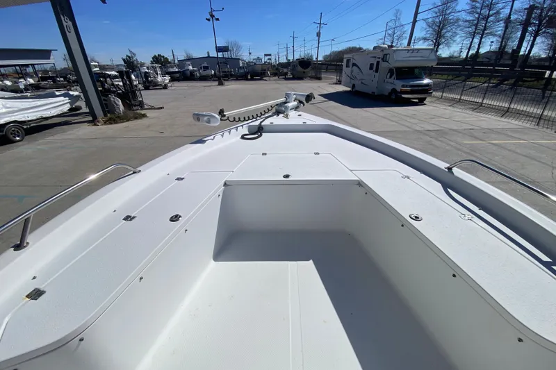 Slide: The Image of 2005 Sea Pro SV2400CC Bay Boat deck view in a marina setting. - 18