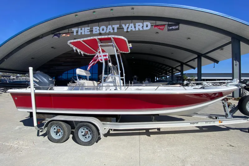 Slide: The Image of 2005 Sea Pro SV2400CC Bay Boat in red, parked at The Boat Yard. - 2