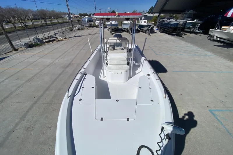 Slide: The Image of 2005 Sea Pro SV2400CC Bay Boat with red canopy, parked in a marina. - 20