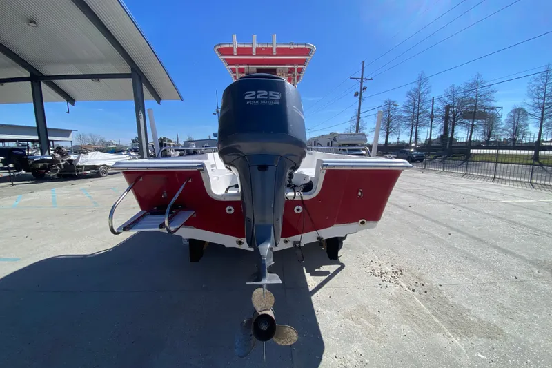 Slide: The Image of 2005 Sea Pro SV2400CC Bay Boat with outboard motor, parked outdoors. - 4