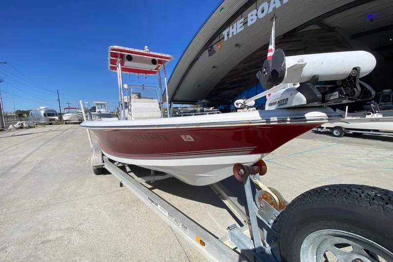 Slide: The Image of 2005 Sea Pro SV2400CC Bay Boat on trailer, red hull, parked outside. - 9