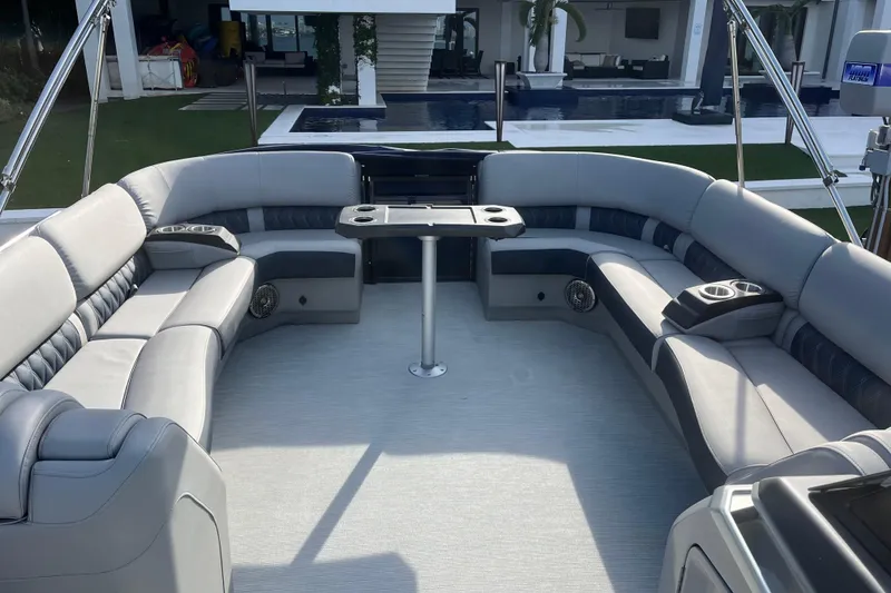 Slide: The Image of Luxurious interior of 2025 Bennington 30 QX Swingback pontoon boat with plush seating and table. - 3