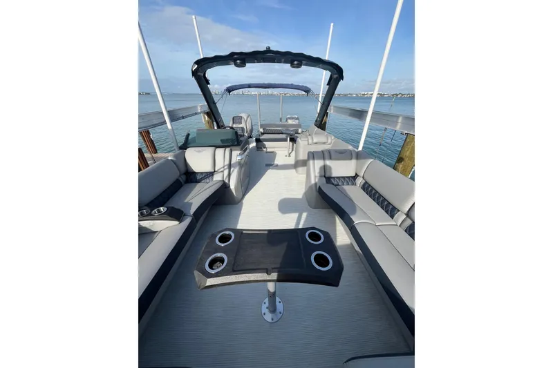 Slide: The Image of 2025 Bennington 30 QX Swingback luxury pontoon boat interior with seating and cup holders. - 4