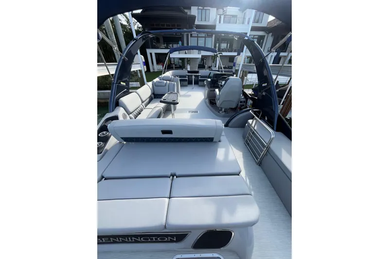 Slide: The Image of 2025 Bennington 30 QX Swingback luxury pontoon boat interior with plush seating and modern design. - 7