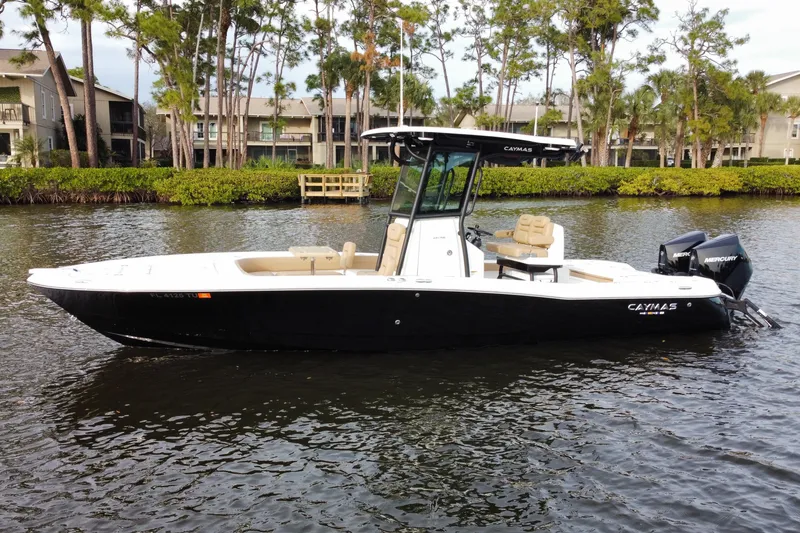 The Image of 2024 Caymas 281 HB boat on water, surrounded by trees and residential buildings. - 0