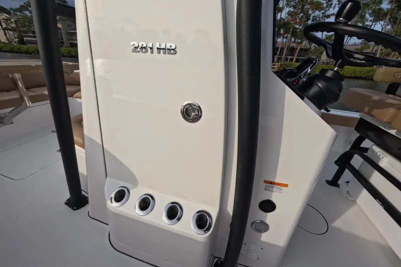 Slide: The Image of 2024 Caymas 281 HB boat console with steering wheel and rod holders. - 13
