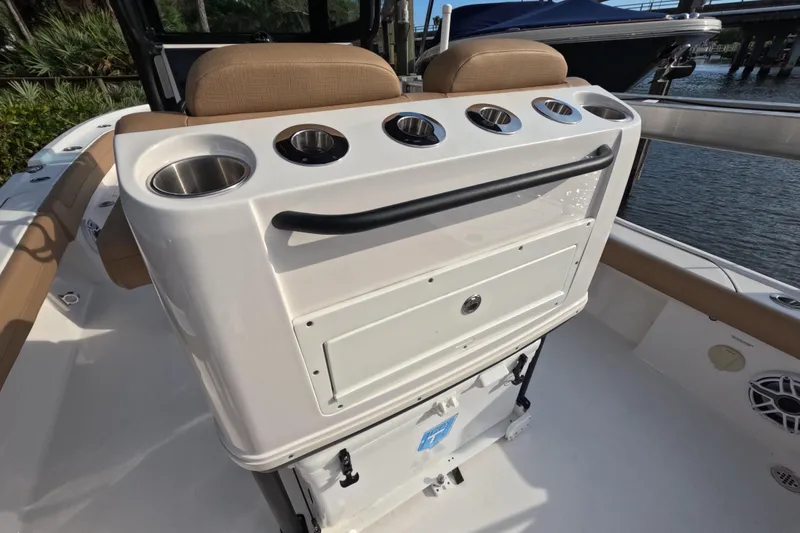 Slide: The Image of 2024 Caymas 281 HB boat interior with cup holders and storage compartment. - 14