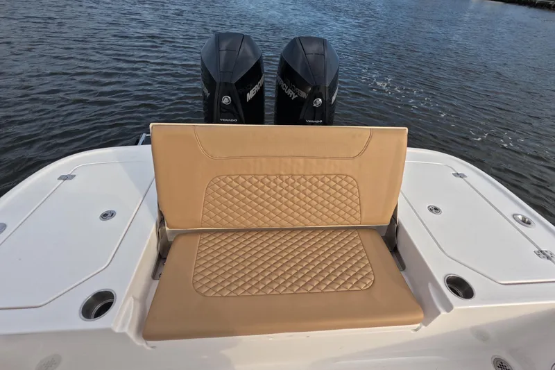 Slide: The Image of 2024 Caymas 281 HB boat with tan quilted seating and dual Mercury engines. - 16