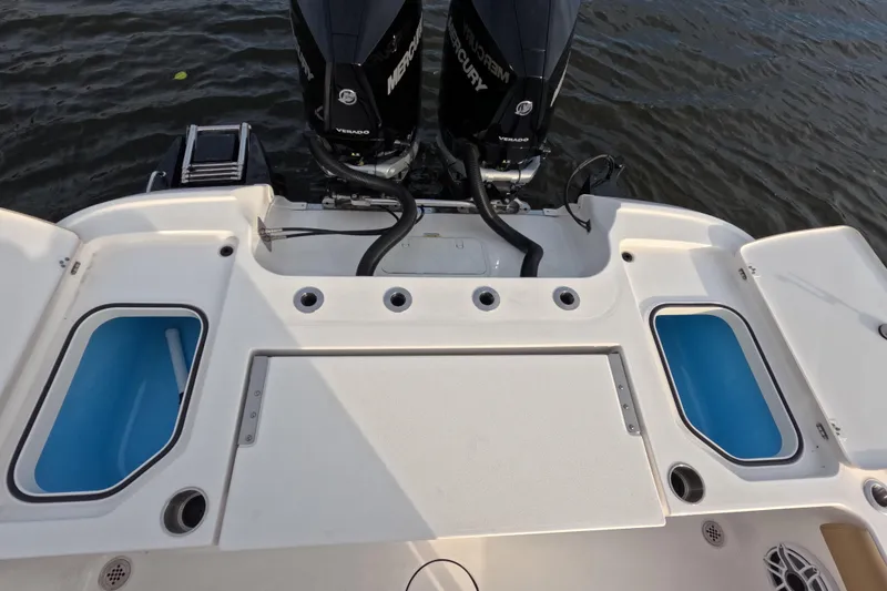 Slide: The Image of 2024 Caymas 281 HB boat with dual Mercury engines and spacious deck layout. - 17