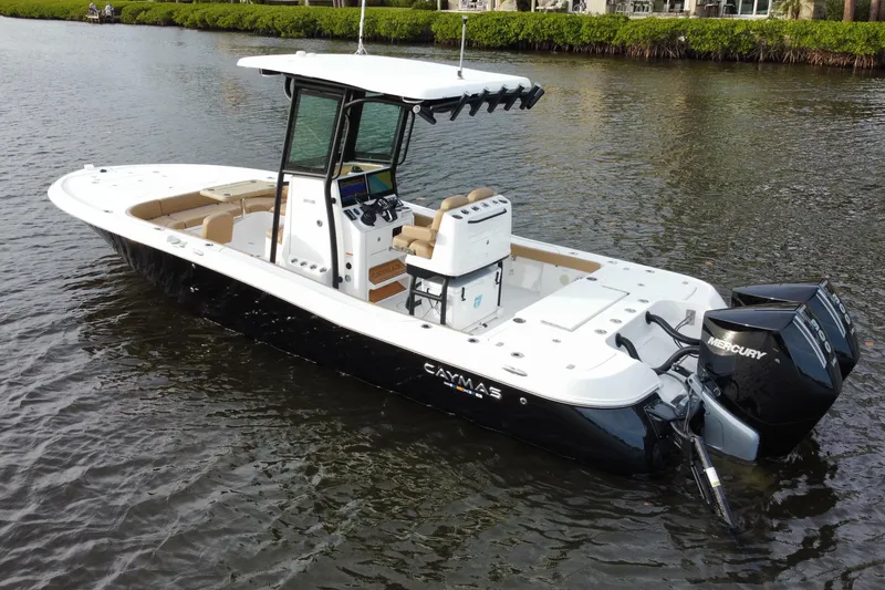 Slide: The Image of 2024 Caymas 281 HB boat with dual Mercury engines on calm water. - 2