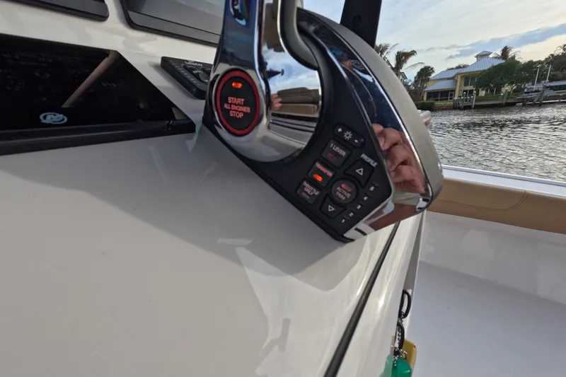 Slide: The Image of 2024 Caymas 281 HB boat control panel with start/stop button and digital display. - 24