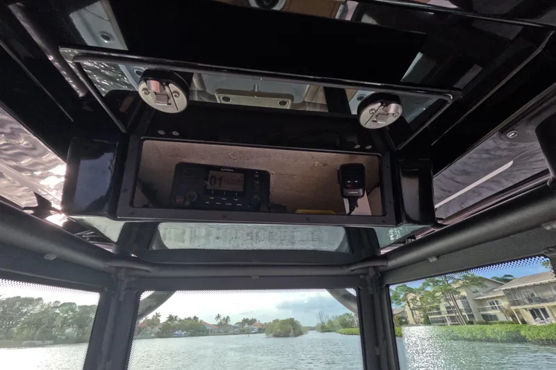 Slide: The Image of 2024 Caymas 281 HB boat interior with Garmin electronics and scenic waterway view. - 25