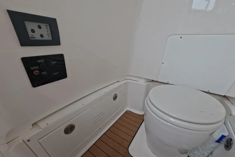 Slide: The Image of 2024 Caymas 281 HB boat interior with toilet and control panels. - 26
