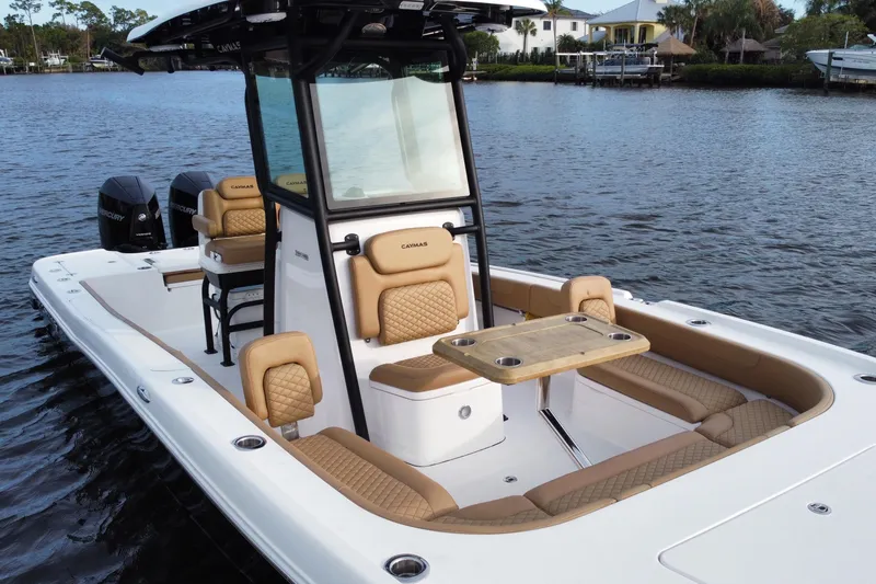 Slide: The Image of 2024 Caymas 281 HB boat with luxurious seating and table on calm water. - 3