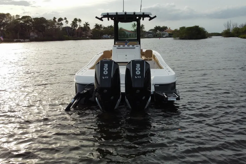 Slide: The Image of 2024 Caymas 281 HB boat with dual 300 V8 engines on a calm waterway. - 4