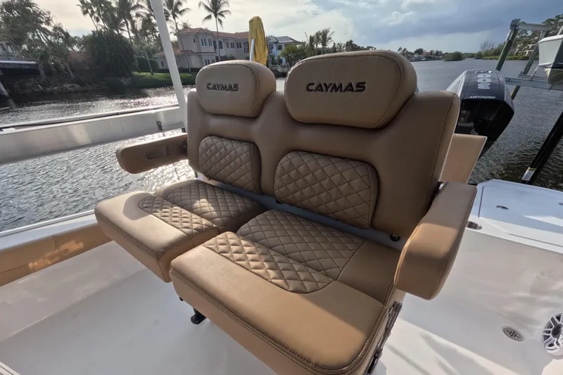 Slide: The Image of 2024 Caymas 281 HB boat with luxurious tan seating by the water. - 5