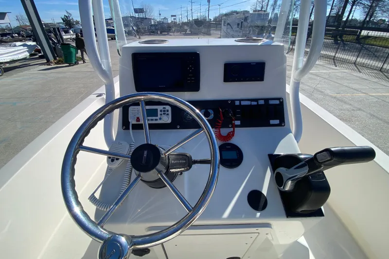 Slide: The Image of 2001 Pathfinder 2400 V boat console with steering wheel and controls. - 15