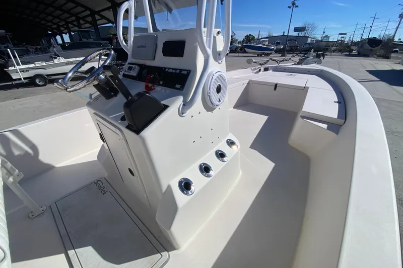 Slide: The Image of 2001 Pathfinder 2400 V boat interior with steering console and navigation equipment. - 17