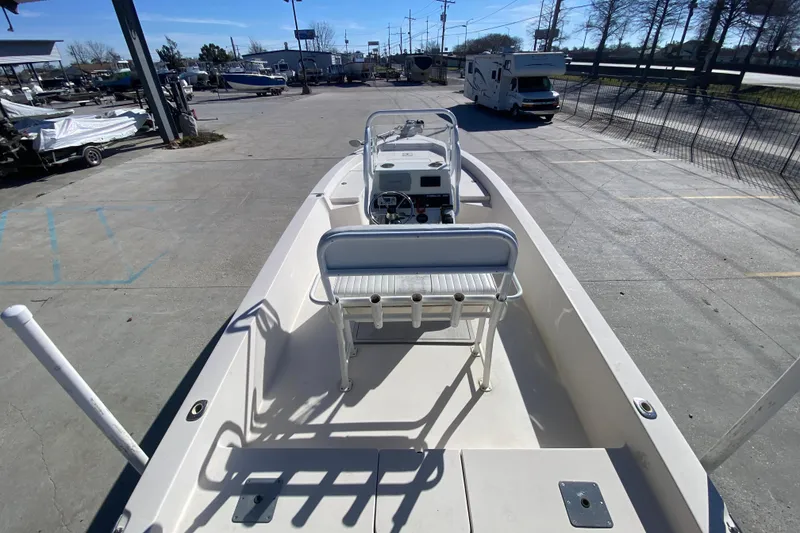 Slide: The Image of 2001 Pathfinder 2400 V boat in a marina, showcasing deck and seating area. - 18