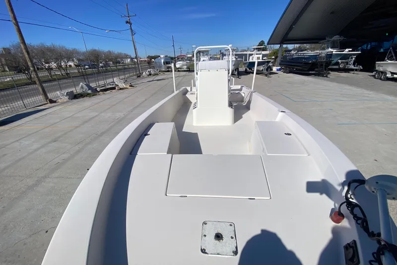 Slide: The Image of 2001 Pathfinder 2400 V boat, spacious deck, parked outdoors under clear blue sky. - 20