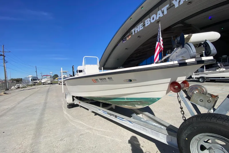 Slide: The Image of 2001 Pathfinder 2400 V boat on trailer outside The Boat Yard, clear blue sky. - 9
