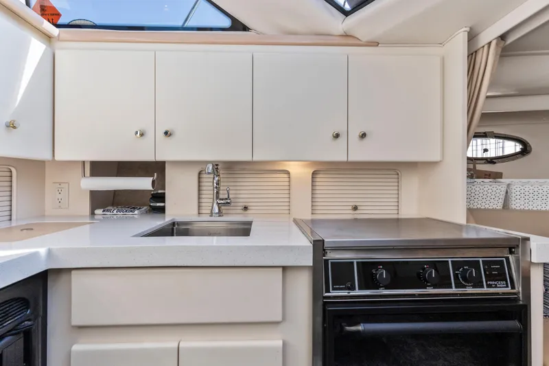 Slide: The Image of Interior of 2000 Carver 326 Aft Cabin Motor Yacht kitchen with stove and sink. - 10