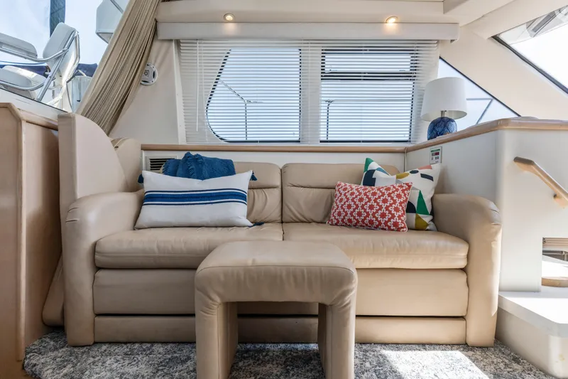 Slide: The Image of Luxurious interior of 2000 Carver 326 Aft Cabin Motor Yacht with plush seating and decorative pillows. - 12