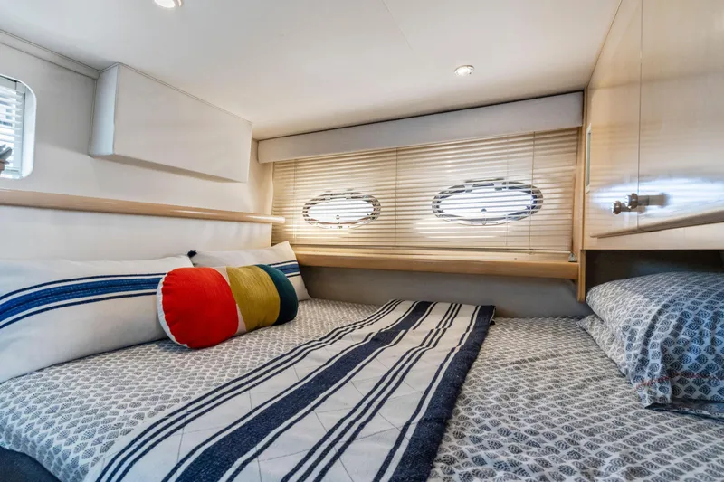 Slide: The Image of Cozy cabin interior of 2000 Carver 326 Aft Cabin Motor Yacht with striped bedding. - 16