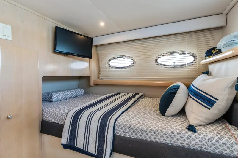 Slide: The Image of Cozy cabin interior of 2000 Carver 326 Aft Cabin Motor Yacht with bed and TV. - 18