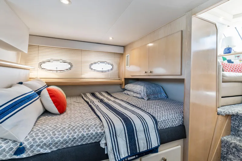 Slide: The Image of Cozy cabin interior of 2000 Carver 326 Aft Cabin Motor Yacht with bed and porthole windows. - 19