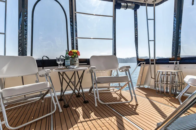 Slide: The Image of Spacious deck of 2000 Carver 326 Aft Cabin Motor Yacht with chairs and table. - 20