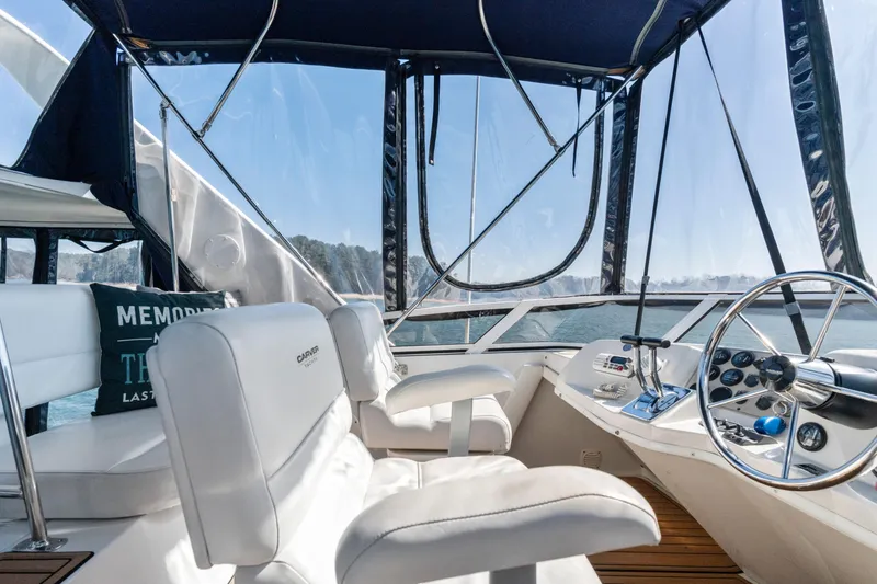 Slide: The Image of Interior view of 2000 Carver 326 Aft Cabin Motor Yacht helm with white seating. - 23