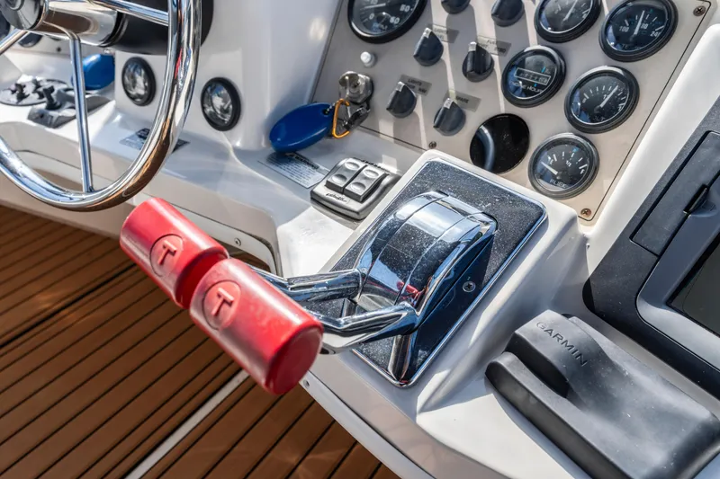Slide: The Image of Control panel of 2000 Carver 326 Aft Cabin Motor Yacht with steering wheel and throttle. - 32
