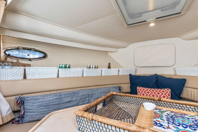 Slide: The Image of Interior of 2000 Carver 326 Aft Cabin Motor Yacht with cozy seating and storage baskets. - 6